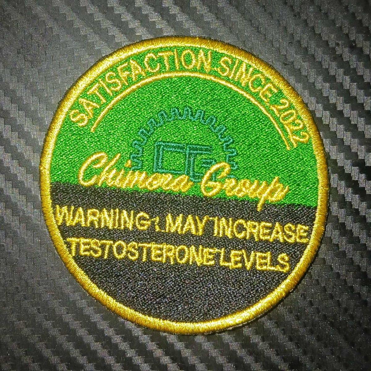 Circular patch with text and logo on a carbon fiber background